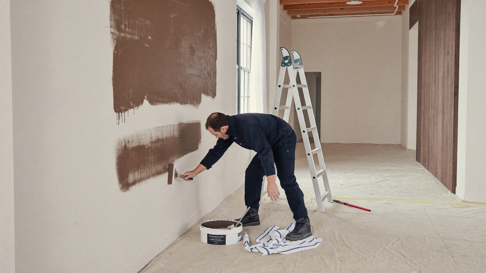Painter rolling a fresh coat on an interior wall